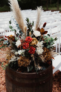 large altar flower arrangment dried flowers green white orange upright