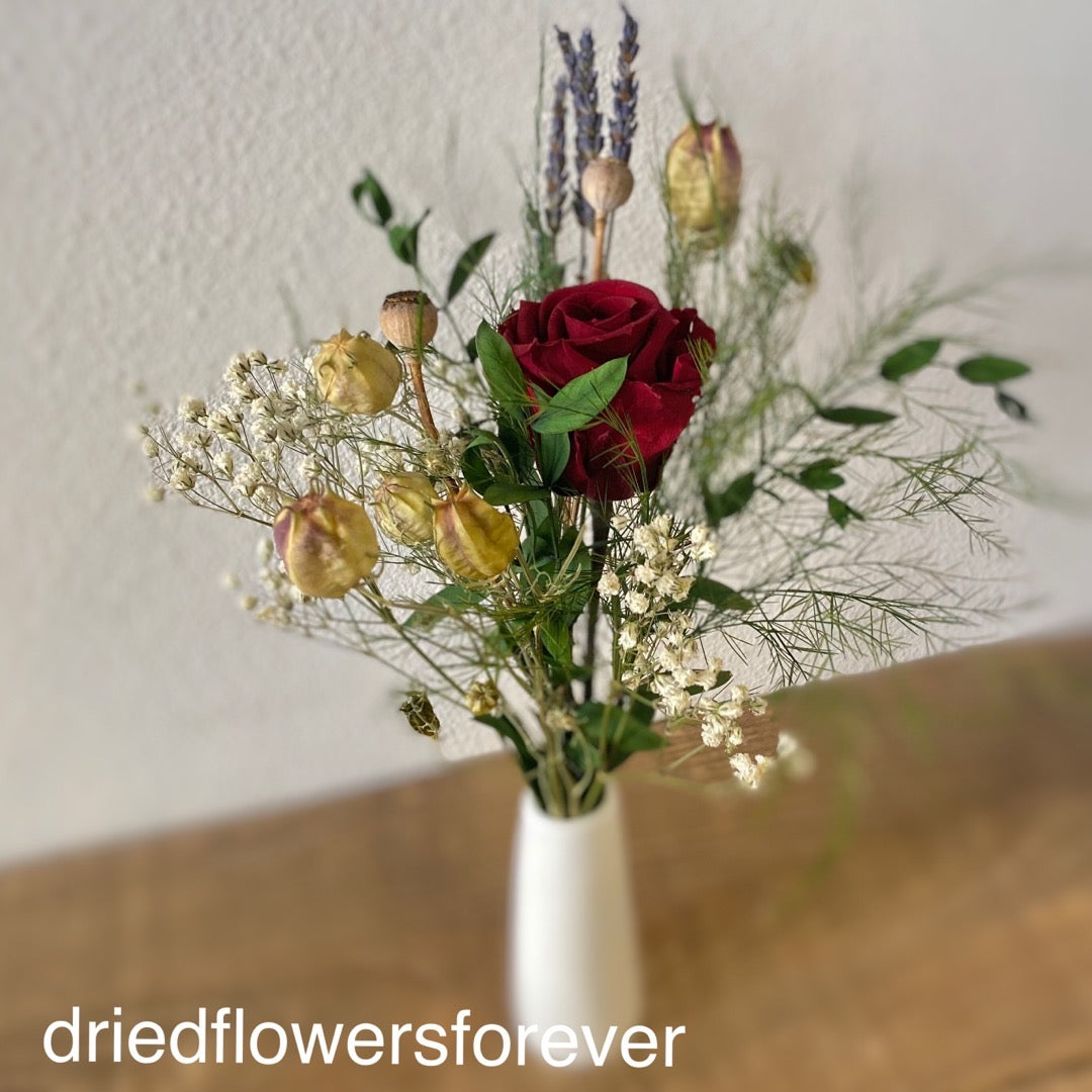 Dried red rose petite flower bouquet with white ceramic bud vase